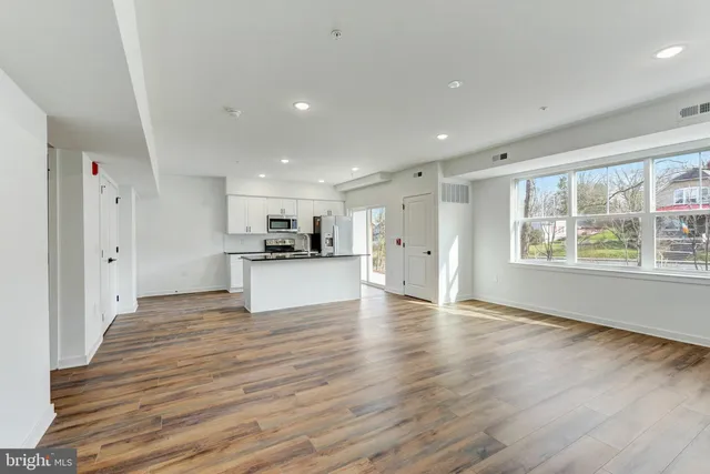 a view of kitchen with wooden floor and window