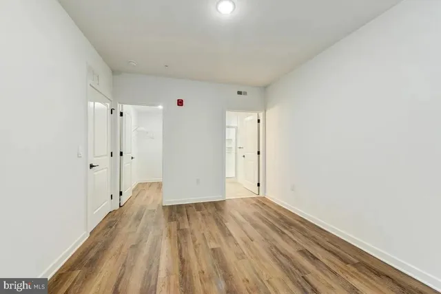 a view of hallway with wooden floor