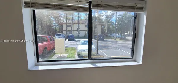 a room with a large window and bed