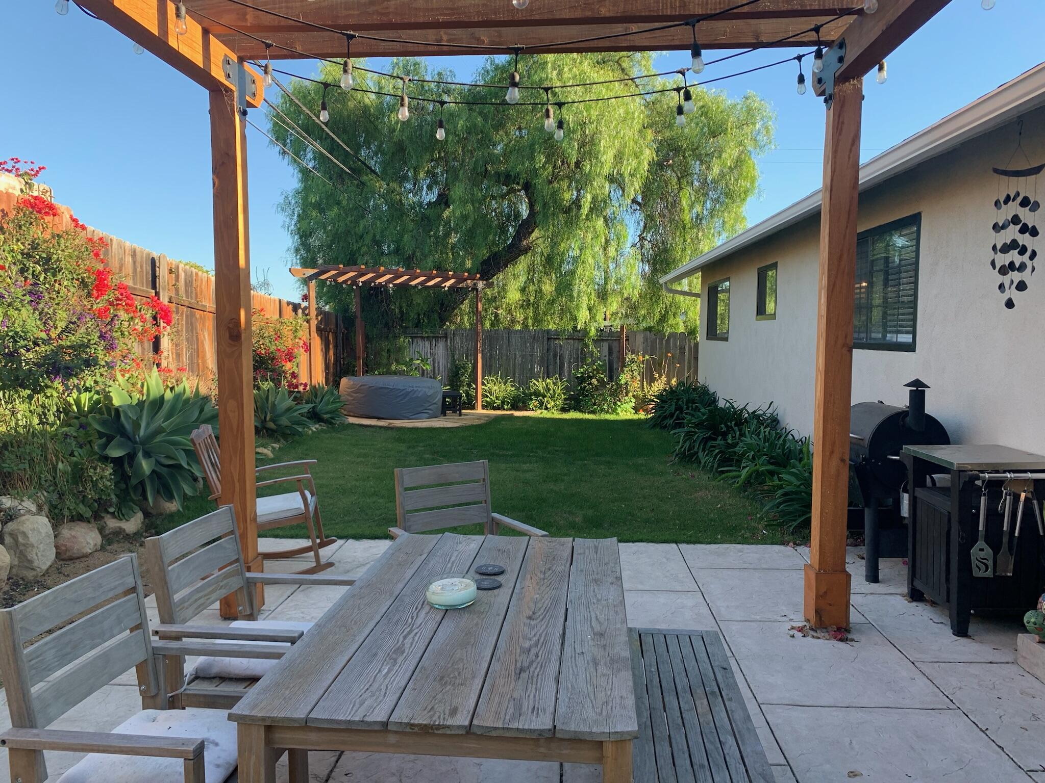 90 Brandon Drive Goleta, CA 93117 - Photo 11 of 11 a view of a patio with table and chairs potted plants and floor to ceiling window