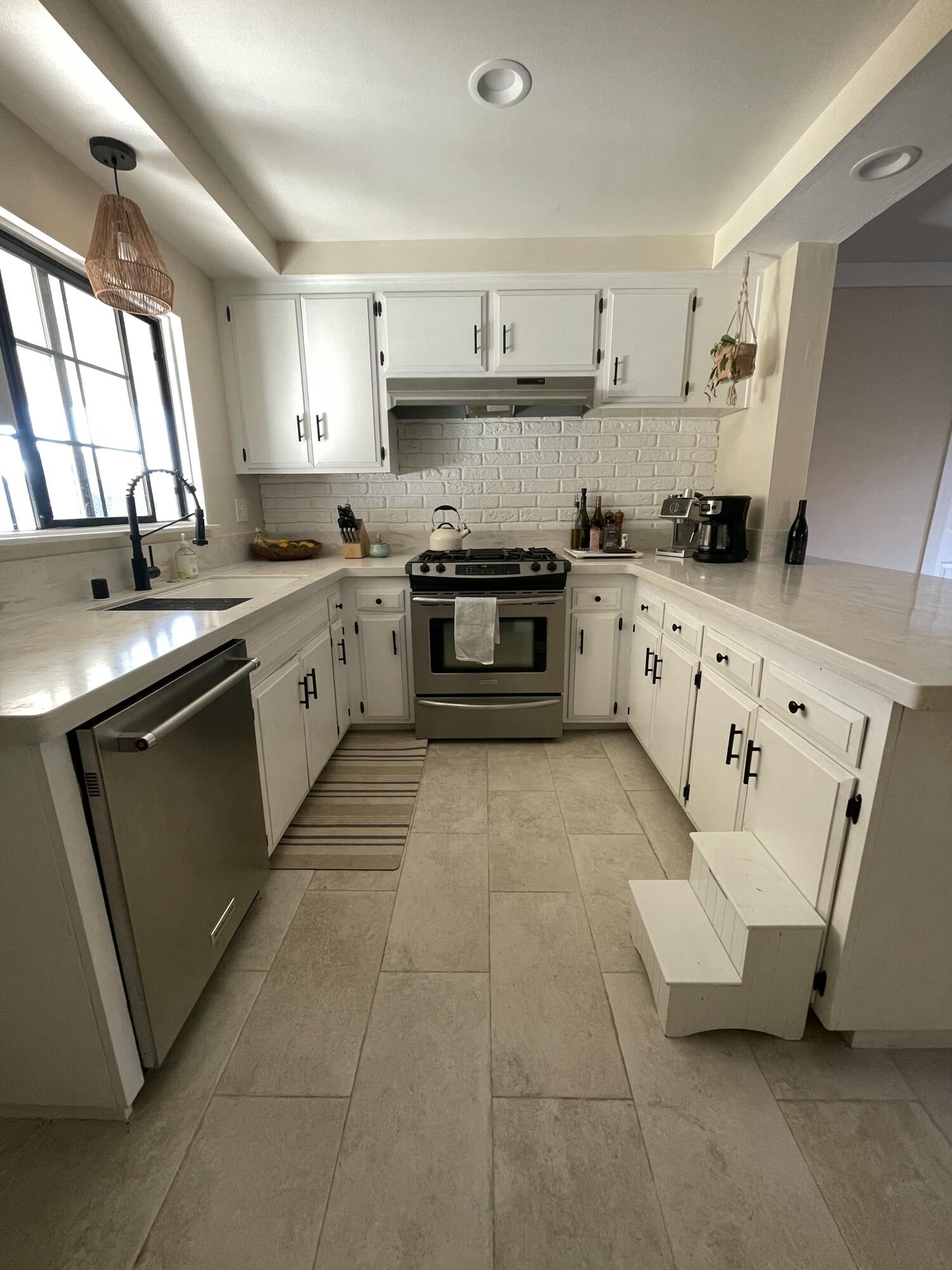 90 Brandon Drive Goleta, CA 93117 - Photo 2 of 11 a kitchen with granite countertop a sink a stove and cabinets