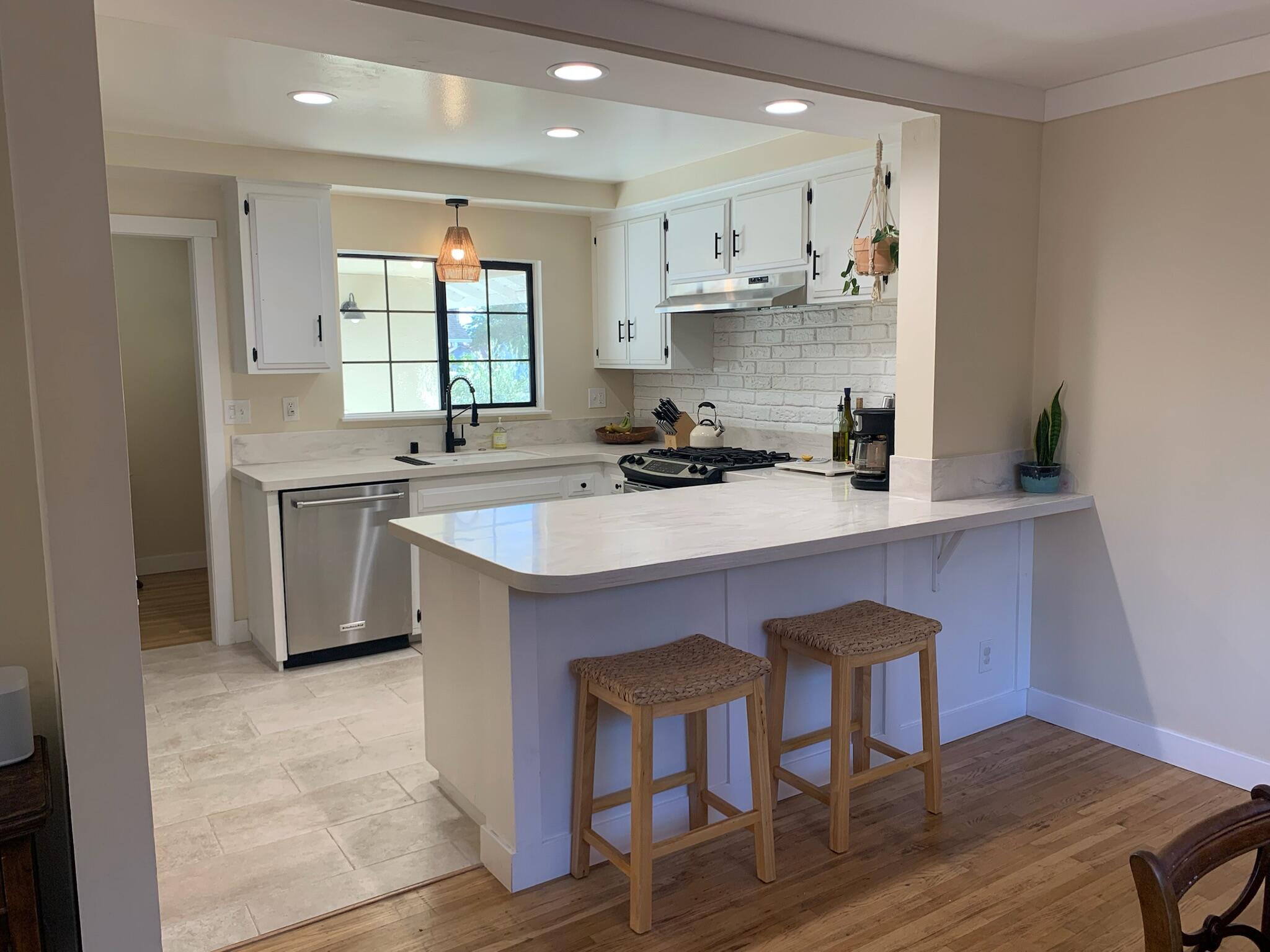 90 Brandon Drive Goleta, CA 93117 - Photo 3 of 11 a kitchen with stainless steel appliances a sink a stove a refrigerator dining table and chairs