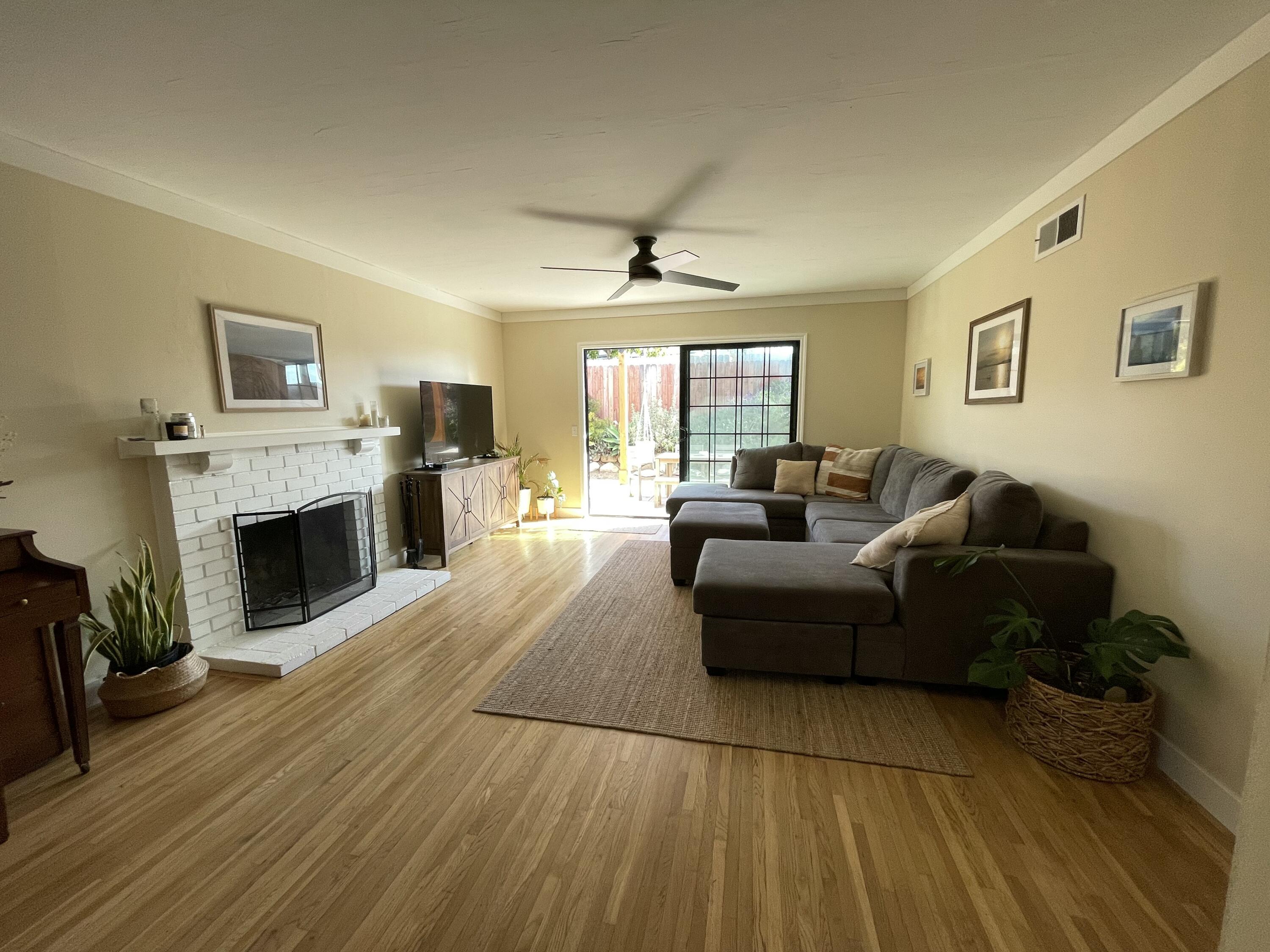 90 Brandon Drive Goleta, CA 93117 - Photo 5 of 11 a living room with furniture a fireplace and a flat screen tv