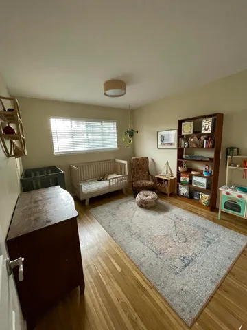 a bedroom with furniture and a wooden floor