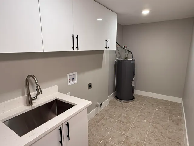a kitchen with a sink and a refrigerator