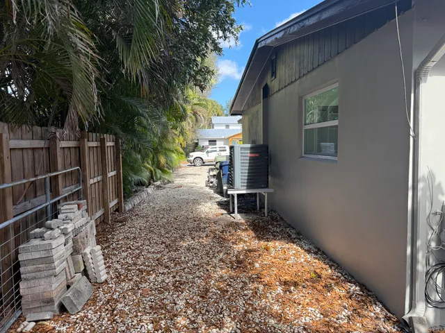a backyard of a house with table and chairs
