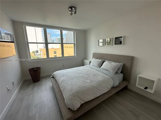 a bedroom with a bed and window