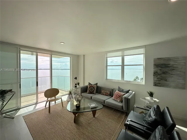 a living room with furniture and a large window