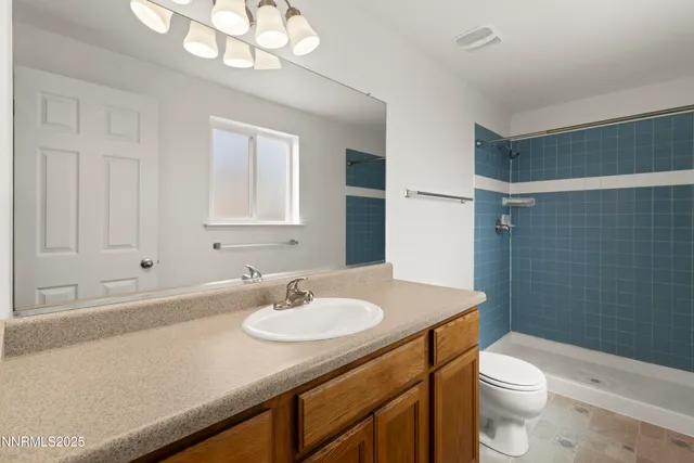 a bathroom with a sink toilet a mirror and shower