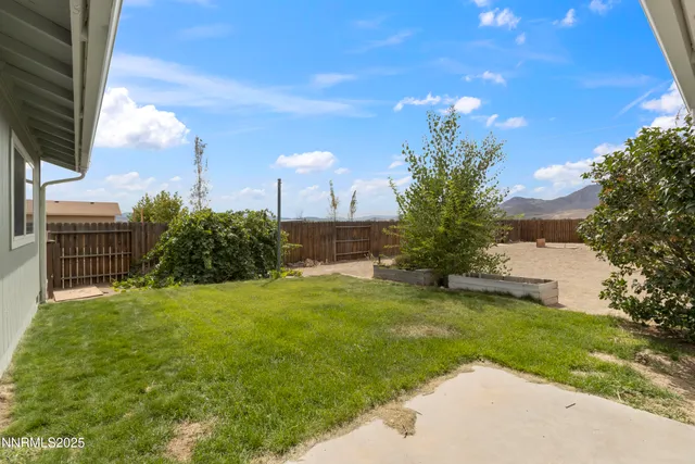 a view of a garden with a house in the background