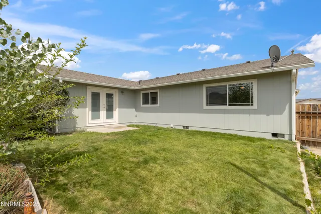 a view of an house with backyard space and balcony