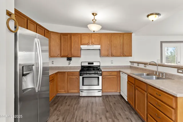 a kitchen with a refrigerator sink and cabinets