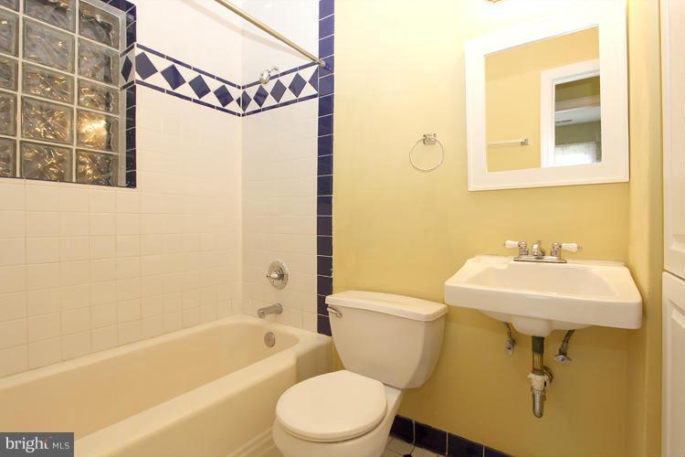 100 Ritchie Avenue Silver Spring, MD 20912 - Photo 13 of 21 a bathroom with a sink a toilet and shower