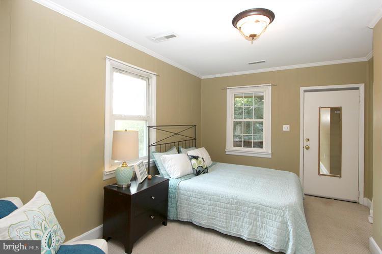 100 Ritchie Avenue Silver Spring, MD 20912 - Photo 14 of 21 a bedroom with a bed and wooden floor