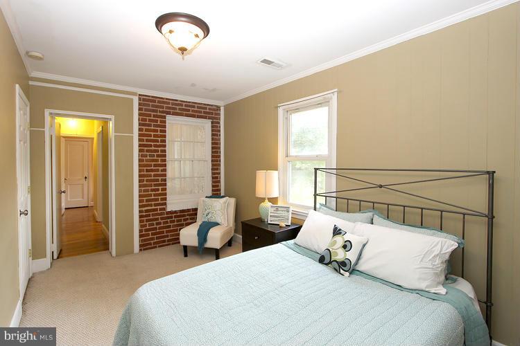 100 Ritchie Avenue Silver Spring, MD 20912 - Photo 15 of 21 a bedroom with a bed and a chandelier