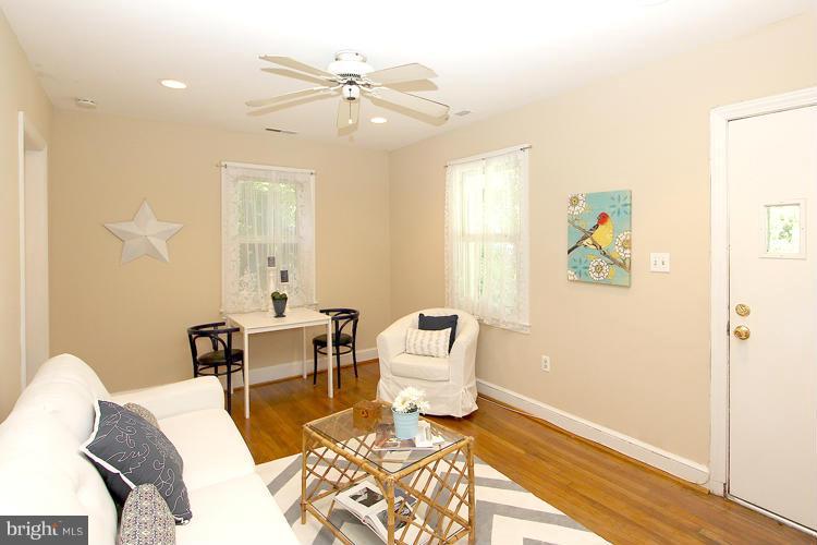 100 Ritchie Avenue Silver Spring, MD 20912 - Photo 5 of 21 a living room with a couch and a table