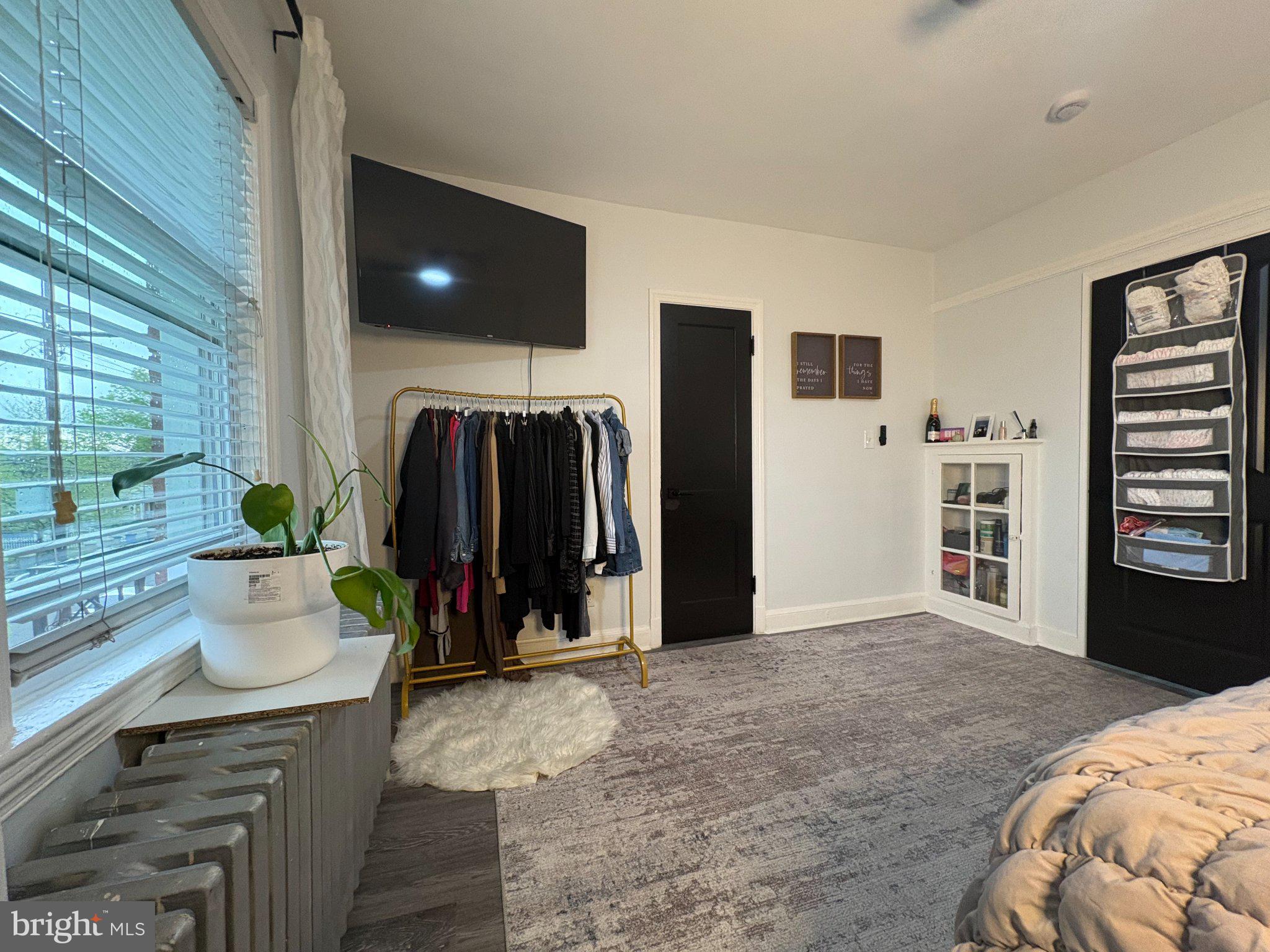 165 35th Street Northeast, Unit 3 Washington, DC 20019 - Photo 4 of 16 a bed room with a bed and a television