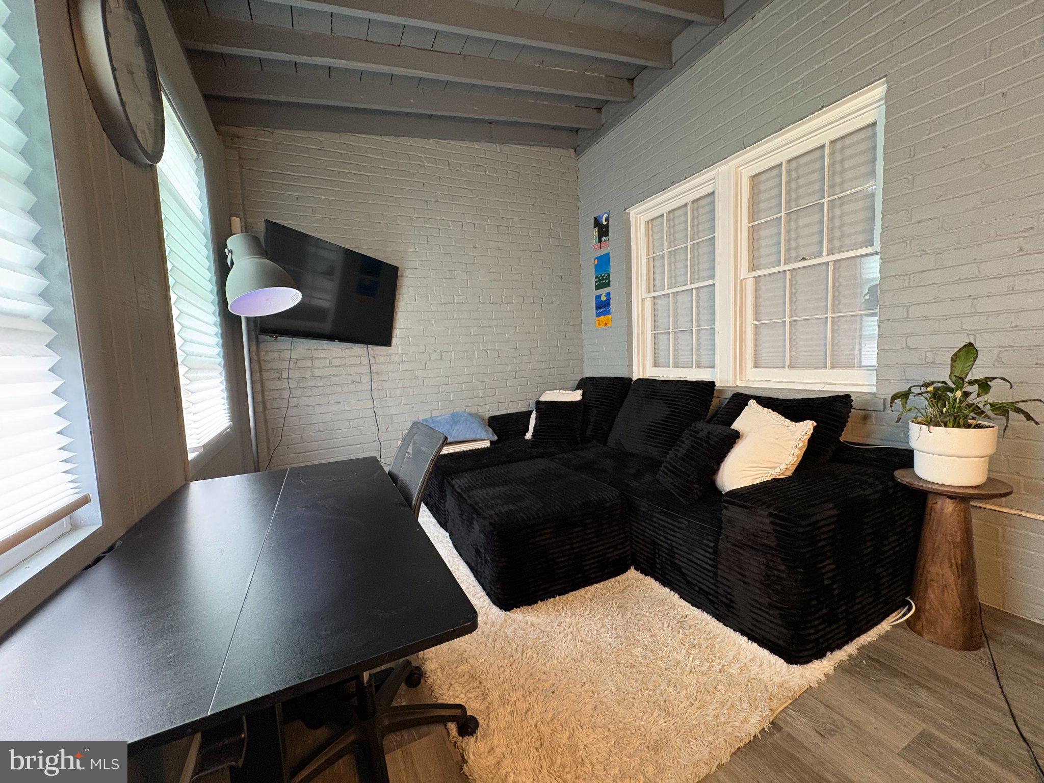 165 35th Street Northeast, Unit 3 Washington, DC 20019 - Photo 5 of 16 a living room with couches and a flat screen tv