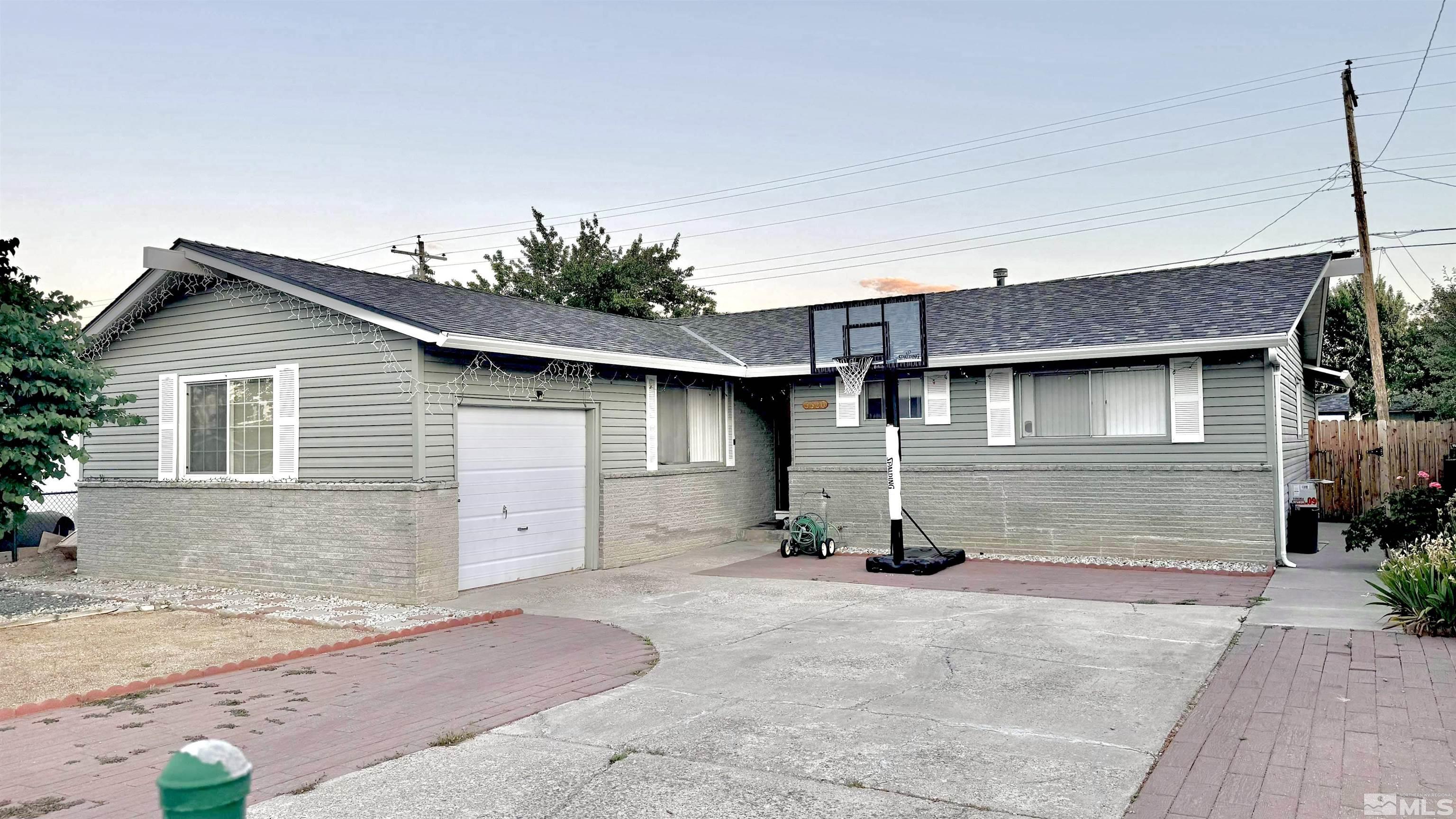 3320 Downey Avenue Reno, NV 89503 - Photo 1 of 20 a view of a house with a yard and garage
