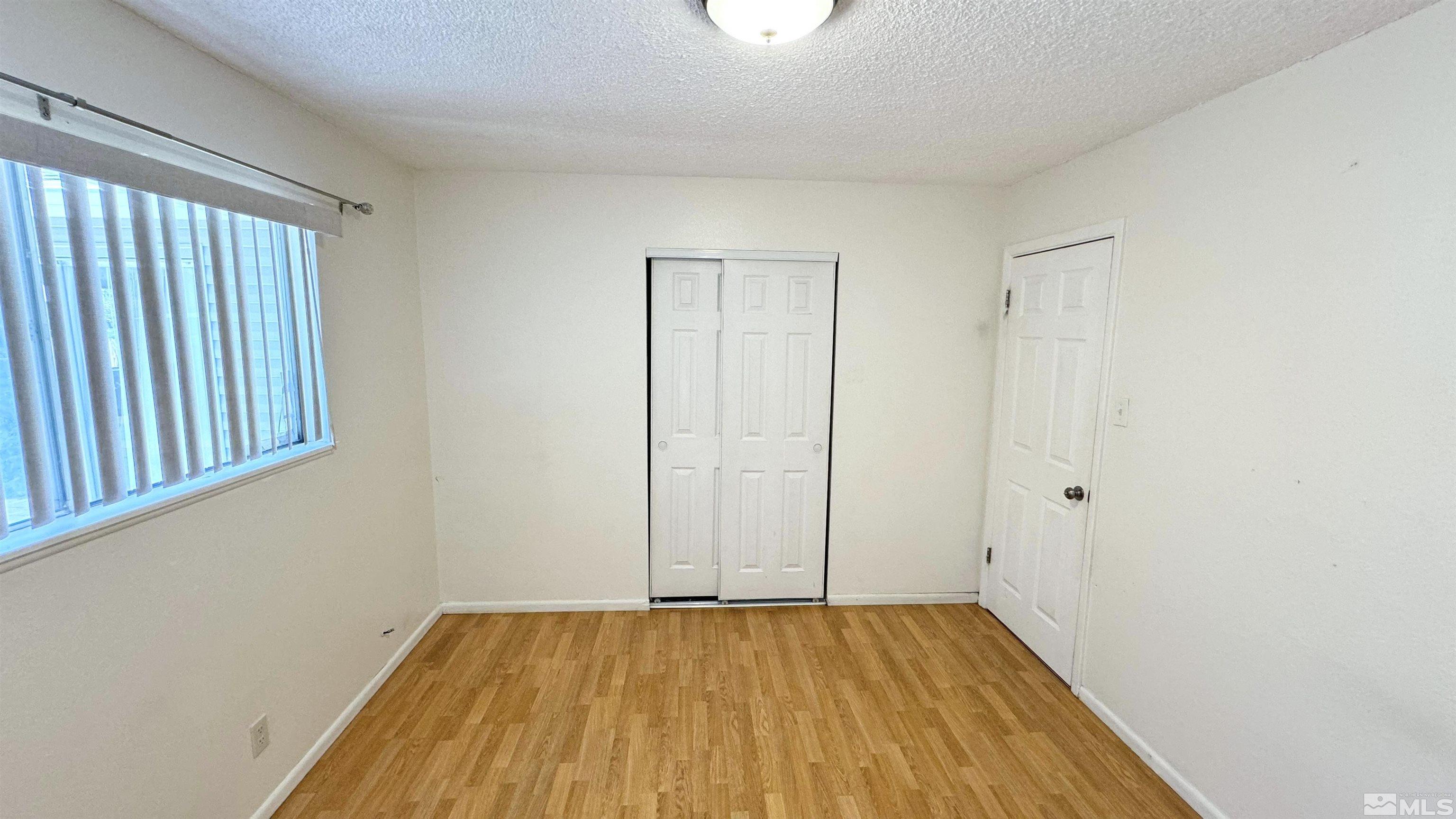 3320 Downey Avenue Reno, NV 89503 - Photo 12 of 20 a view of an empty room with wooden floor and a window