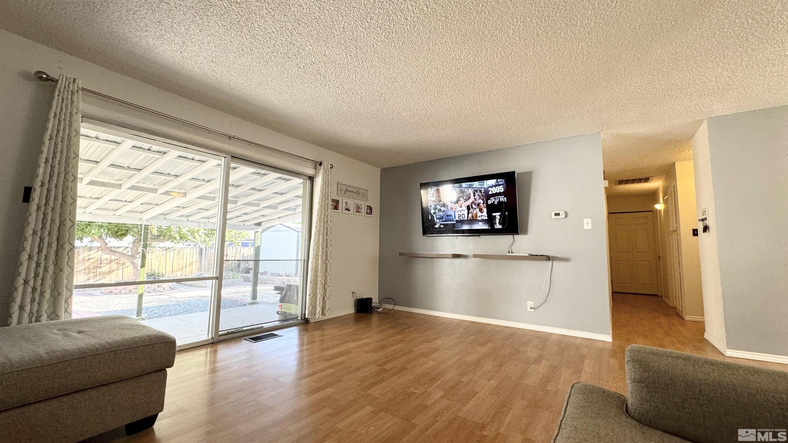 3320 Downey Avenue Reno, NV 89503 - Photo 14 of 20 a view of a living room with furniture and a flat screen tv