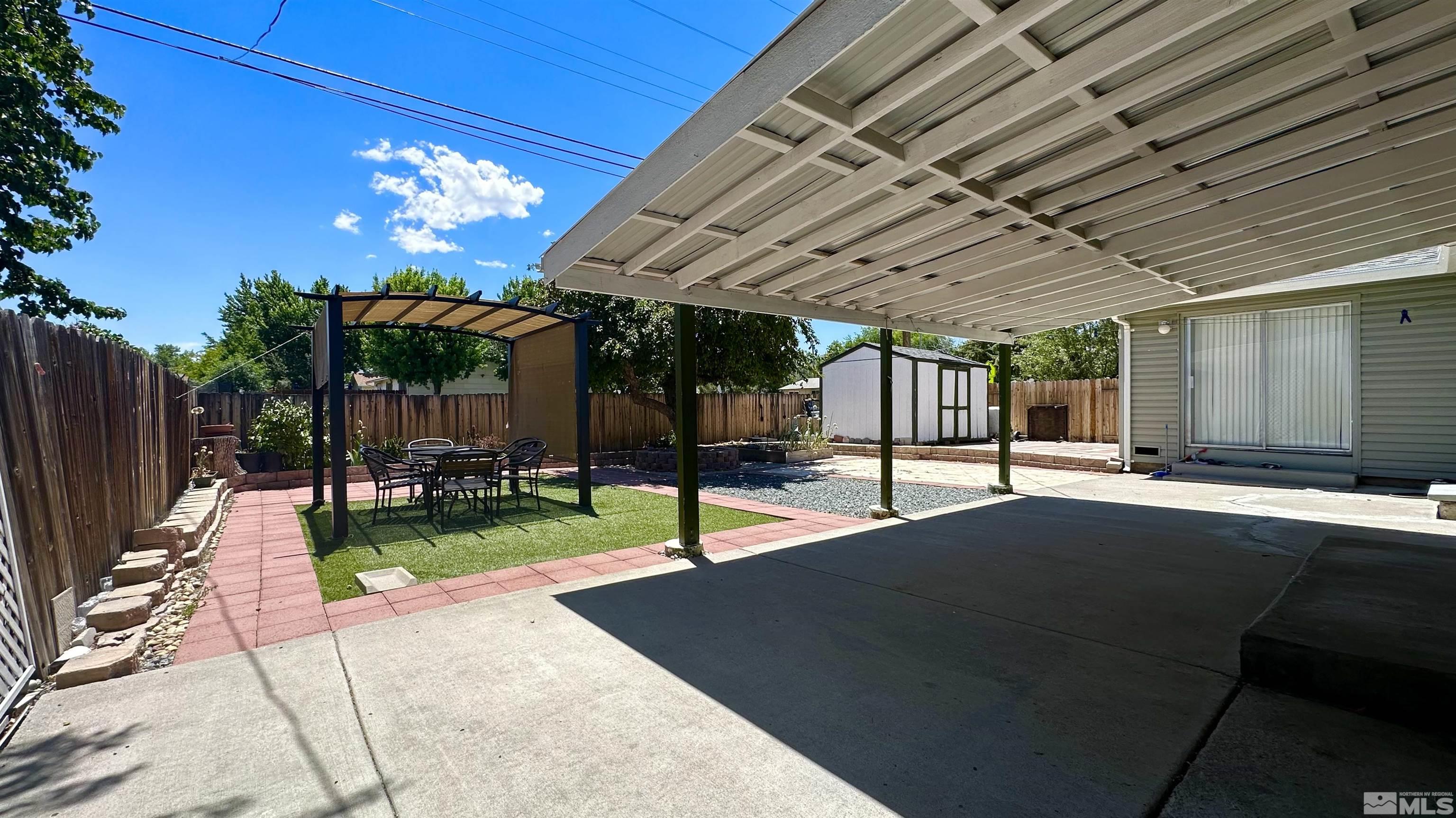 3320 Downey Avenue Reno, NV 89503 - Photo 18 of 20 a view of a patio with table and chairs potted plants with wooden fence