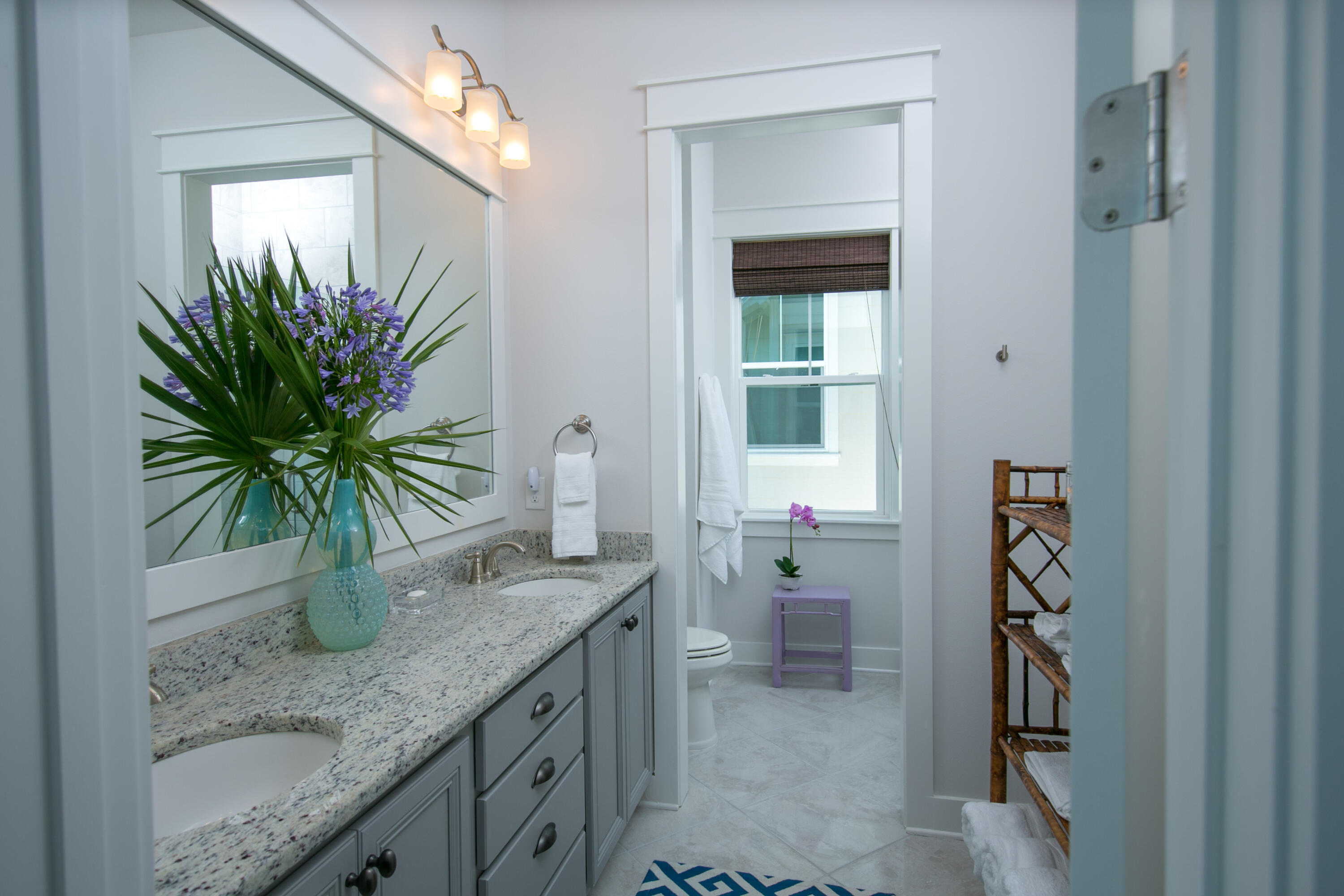 85 York Ln Inlet Beach, Unit B Inlet Beach, FL 32461 - Photo 6 of 31 a bathroom with a granite countertop sink a mirror and a shower