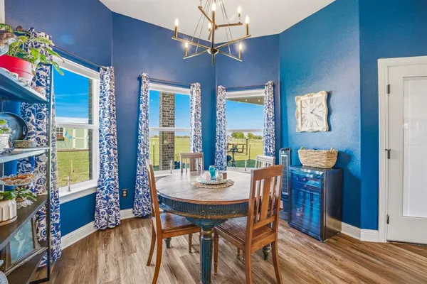 a view of a dining room with furniture and chandelier