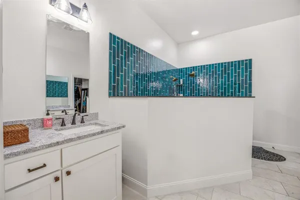 a bathroom with a sink and a mirror