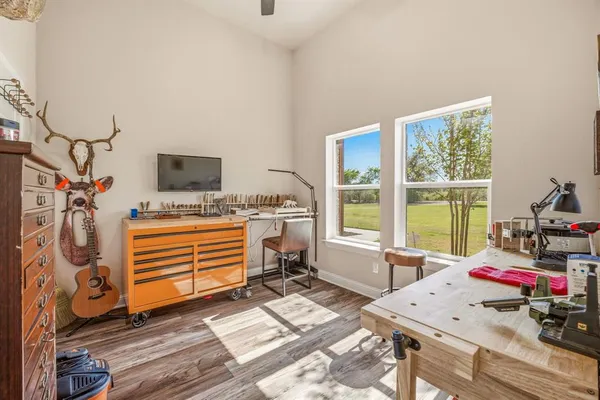 a view of a workspace with furniture and a window
