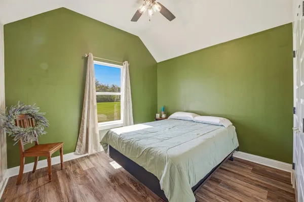 a bedroom with a bed and a chair