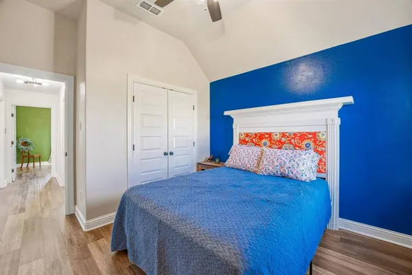 a bed sitting in a bedroom next to a window