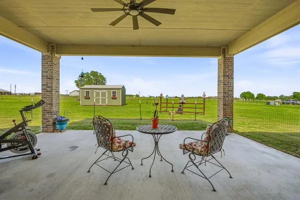 a view of a swimming pool and chairs in a patio