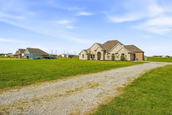 a view of a house with a yard and garage