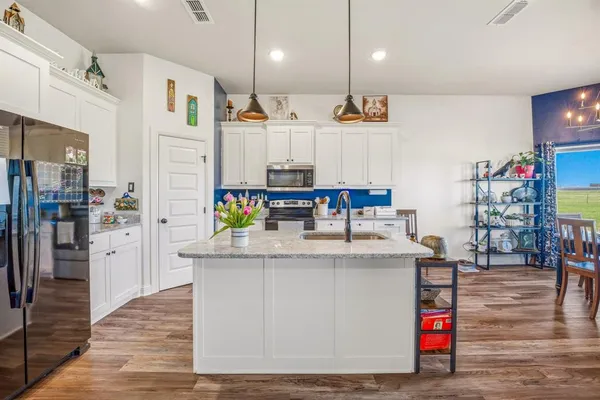 a kitchen with stainless steel appliances granite countertop a stove and a refrigerator