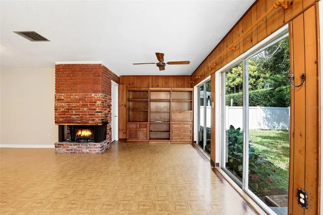 a view of an empty room with a fireplace