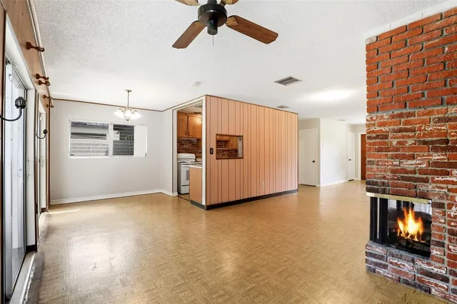 a view of a livingroom with a fireplace and window