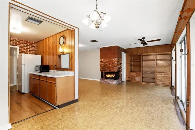 a view of kitchen with stainless steel appliances granite countertop a stove and a refrigerator