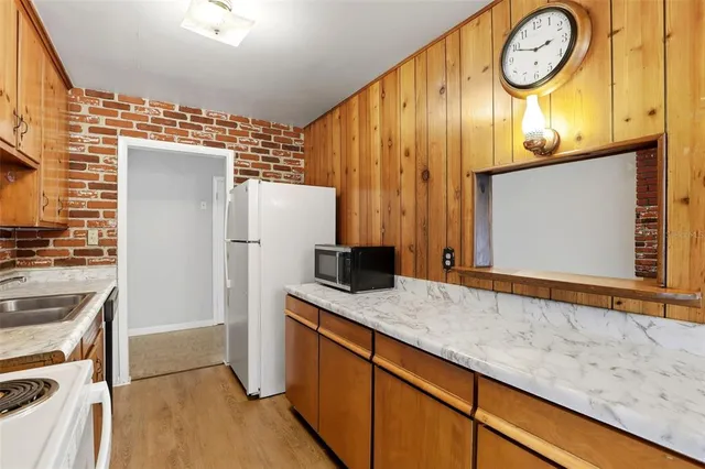 a kitchen with stainless steel appliances granite countertop a refrigerator and a stove
