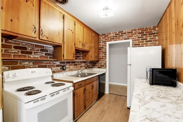 a kitchen with stainless steel appliances a stove a sink and a refrigerator