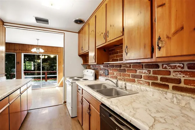 a kitchen with stainless steel appliances a sink and cabinets