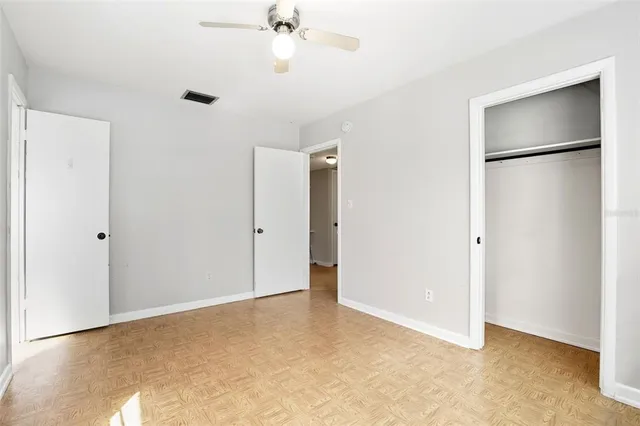 a view of an empty room with a ceiling fan