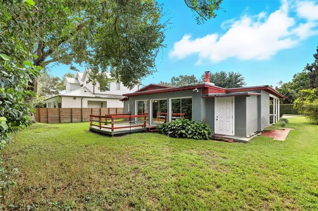 a view of a house with a yard and sitting area