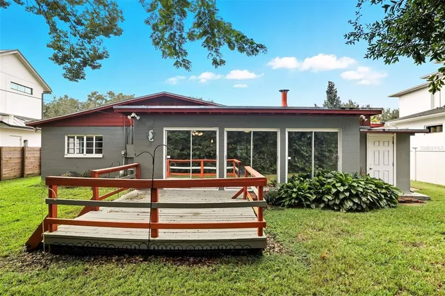a view of house with a yard and sitting area
