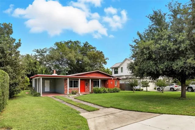 a front view of a house with a garden