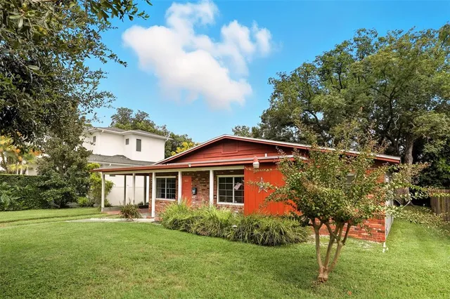 a front view of a house with a garden