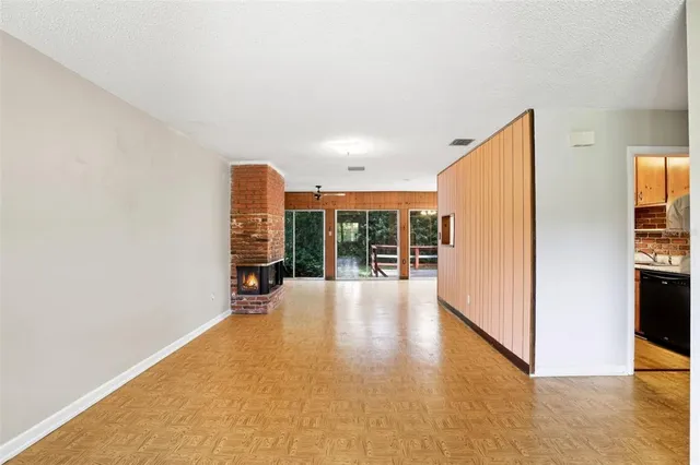 a view of a living room with furniture and kitchen view