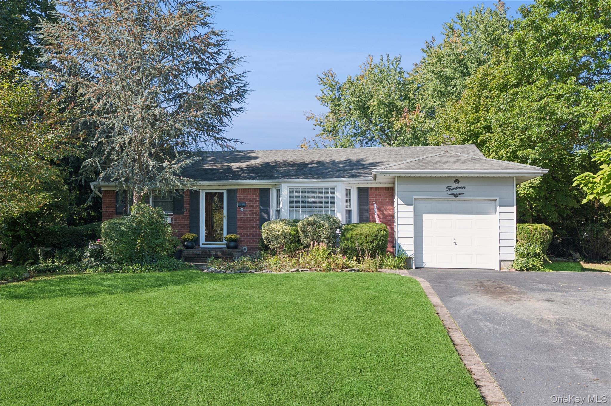 a front view of house with a garden and patio