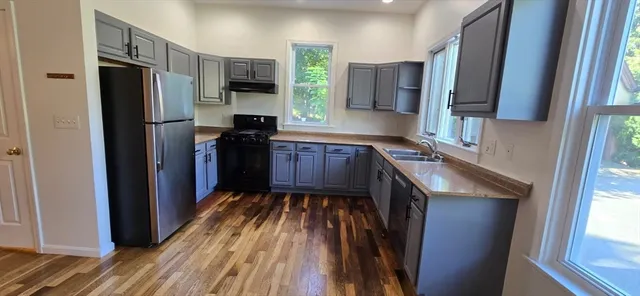 a kitchen with stainless steel appliances granite countertop a refrigerator stove and sink