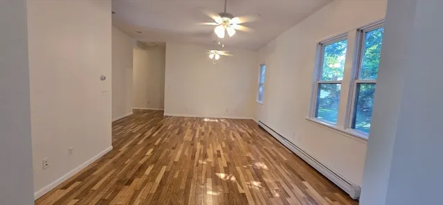 wooden floor in an empty room with a window